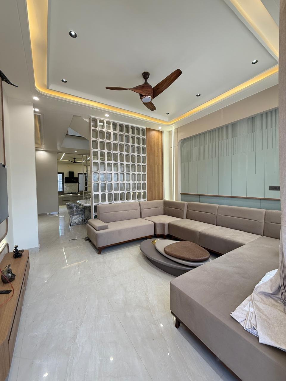 Living room with L-shaped sofa and jaali partition