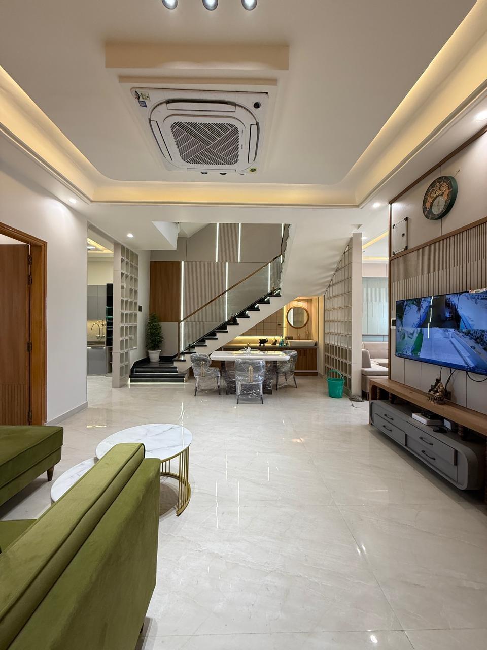 Living area with TV unit and staircase