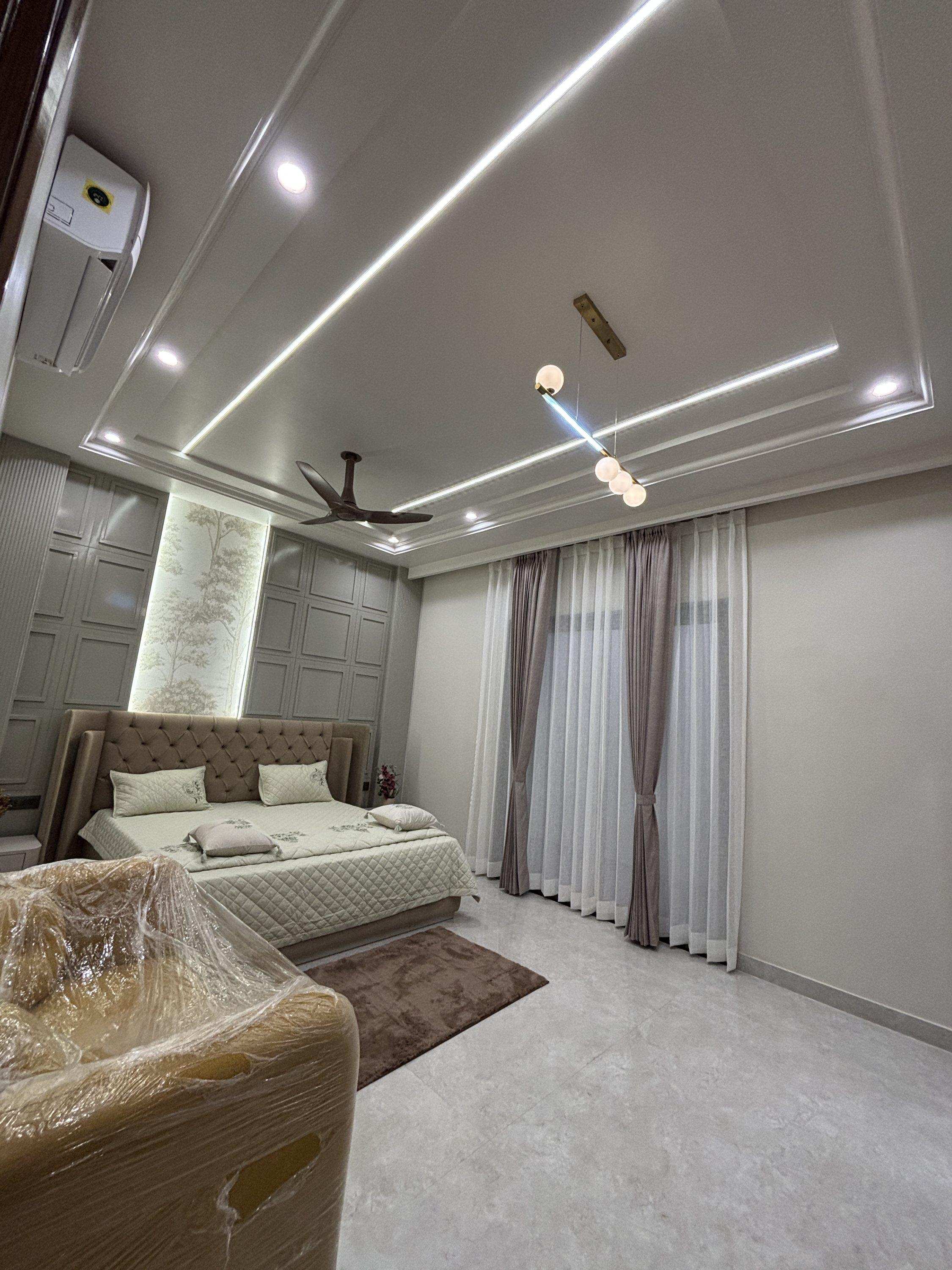 Bedroom with cove lighting and wardrobe