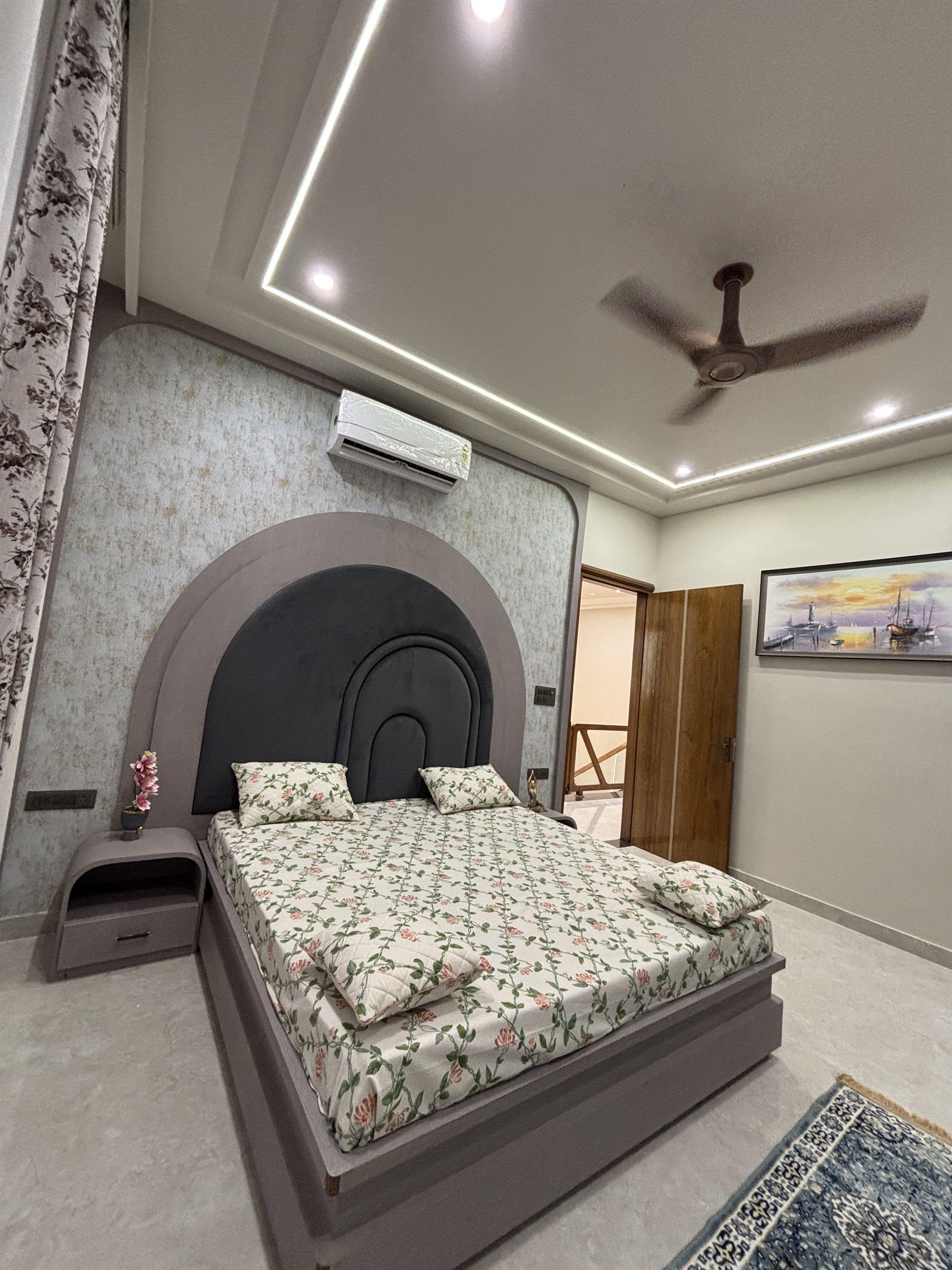 Bedroom with arched headboard wall