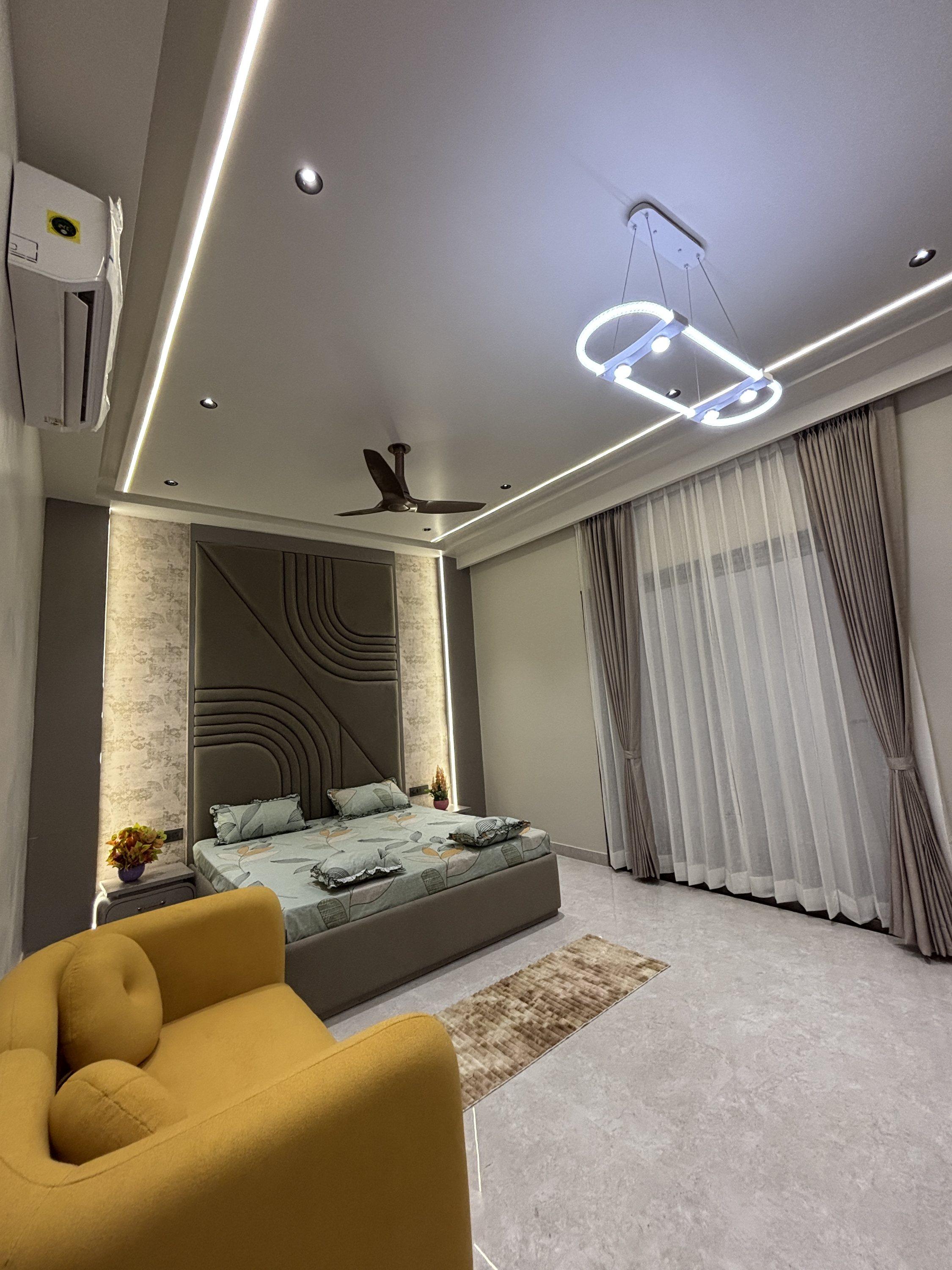 Bedroom with sofa and statement light